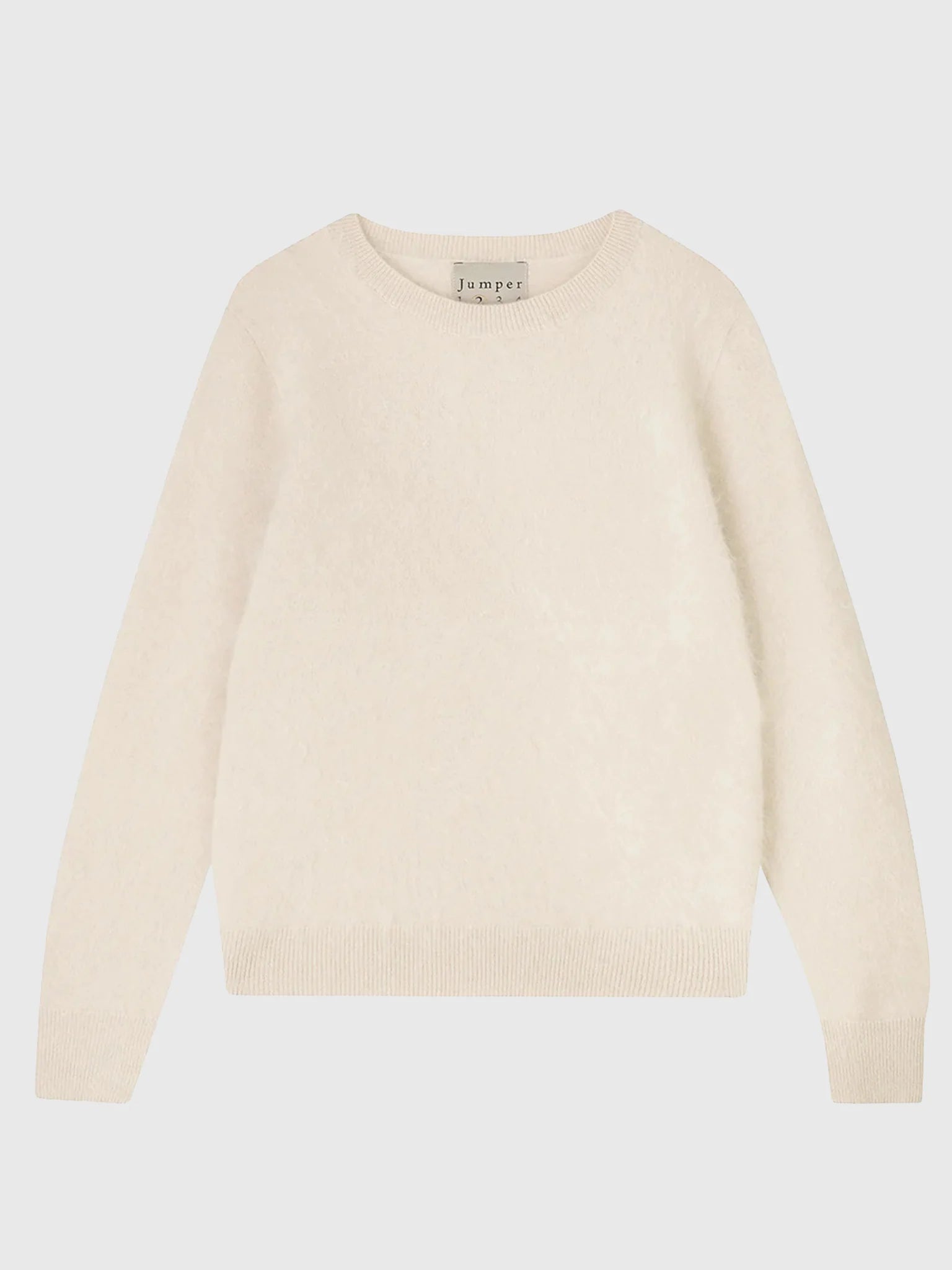 The Brushed Crew by Jumper 1 2 3 4/CR2 is a plain long-sleeve off-white cashmere jumper with ribbed cuffs and hem, shown laid flat on a light background.