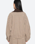 A person with long dark hair is seen from behind, wearing the Sea New York Savannah Plaid Jacket with a loose, modern fit and an oversized ribbed-knit collar against a plain white background.