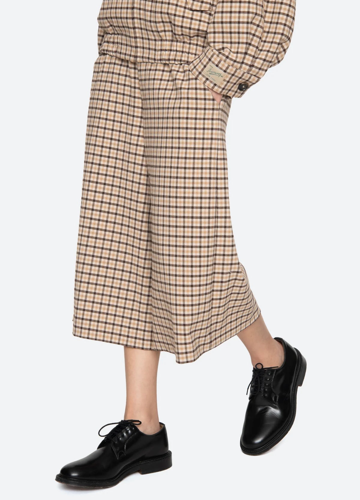 A person wearing the Sea New York Savannah Plaid Culotte with a matching top and black leather lace-up shoes stands against a plain white background.