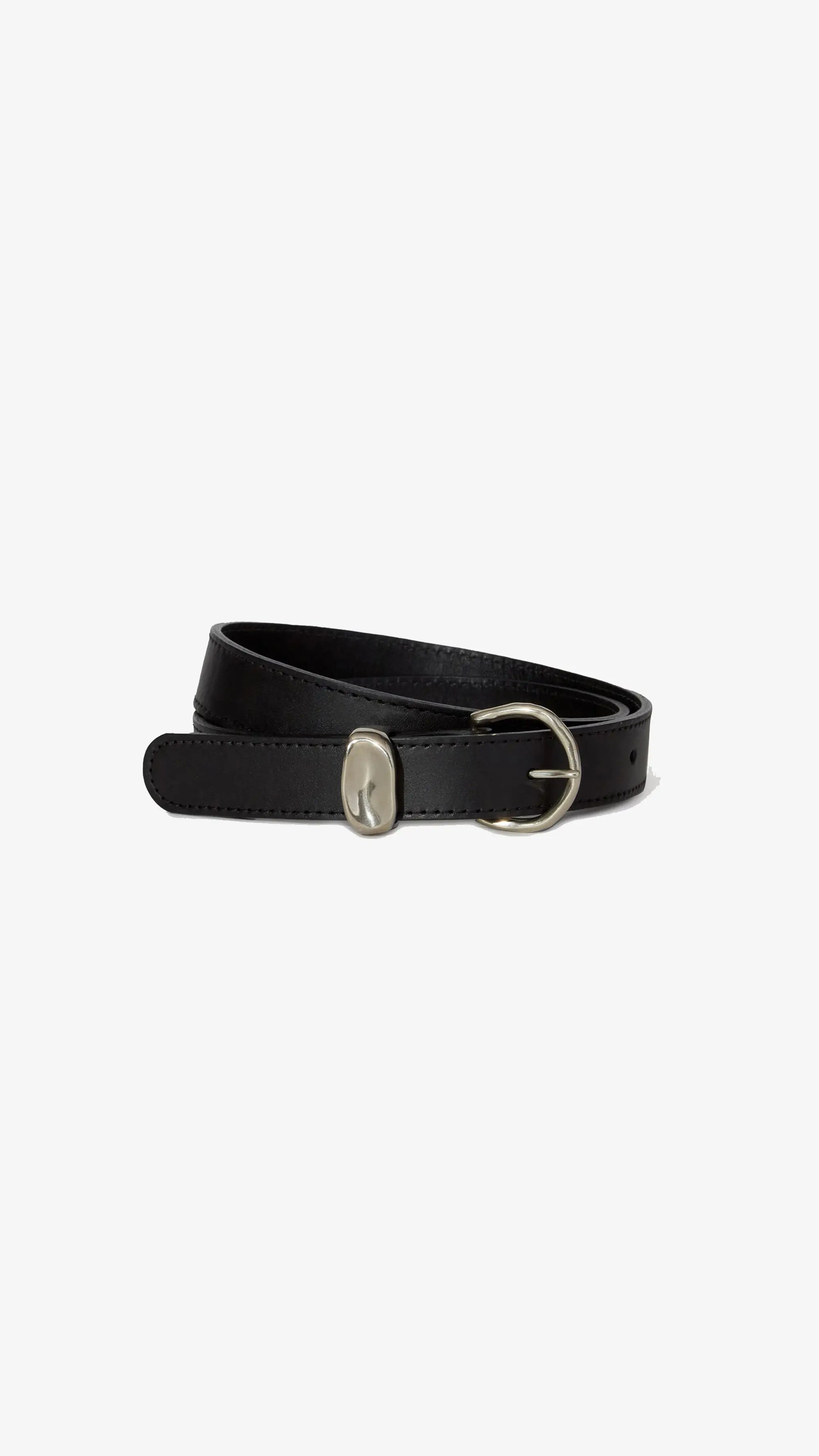 The Janessa Leone Myra belt, crafted from black leather and finished with a rounded silver buckle, is showcased coiled on a simple white background.