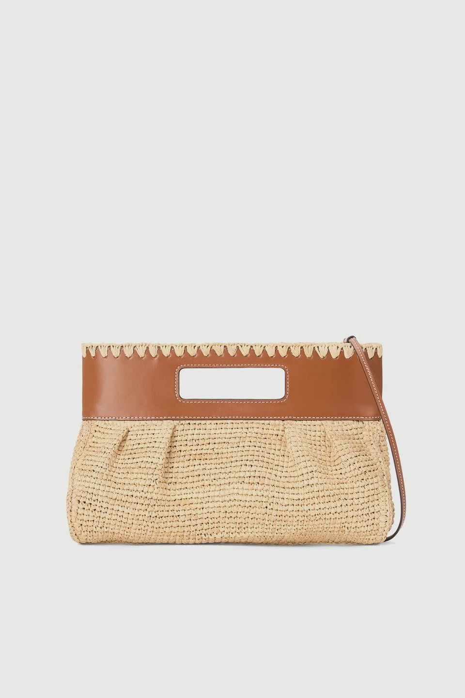 The Staud Lena Raffia Clutch features a rectangular straw design with brown leather trim, scalloped edges, a cutout handle, and detachable wrist strap. Its woven texture and neutral tones make it versatile for any outfit.