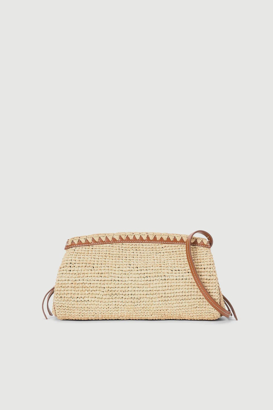 The Staud Maude Convertible Clutch in natural features a small, rectangular woven raffia design with brown leather trim and a convertible leather shoulder strap, shown against a plain white background.