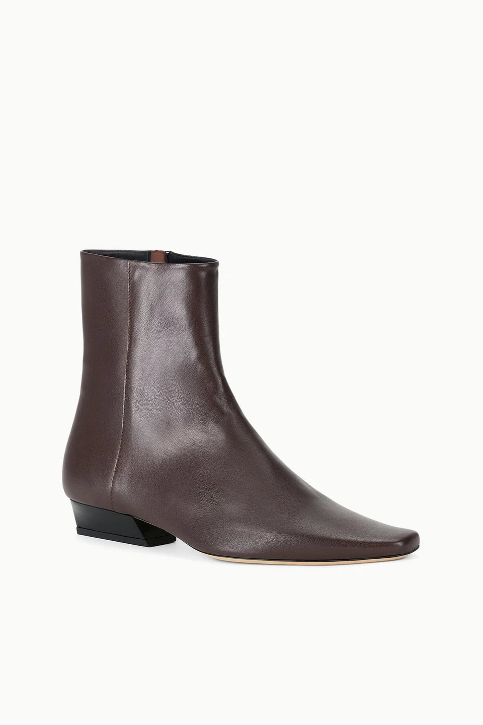 Brown leather ankle boot with pointed toe and low black heel by Staud, Wally Sock style on white background.