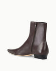 Brown lamb leather ankle boot with pointed toe, side zipper, and low square heel by Staud, Wally Sock Flat style.