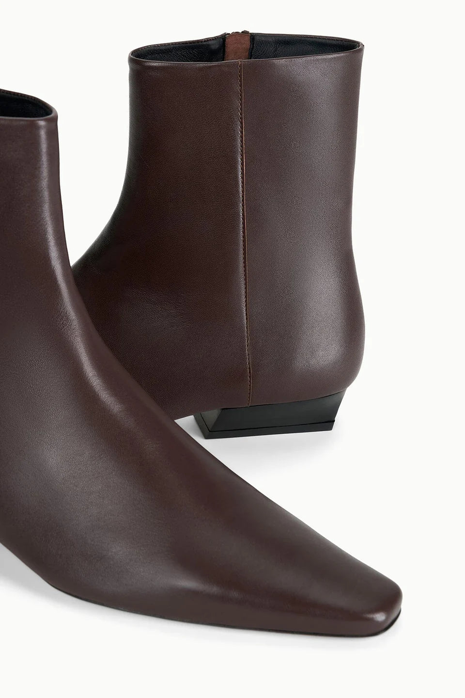 Brown lamb leather ankle boot with pointed toe and low black heel by Staud, the Wally Sock Flat style.