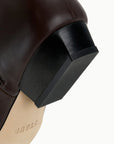Black Staud Wally Sock Flat Ankle Boot with pointed toe, geometric heel, and branded sole.