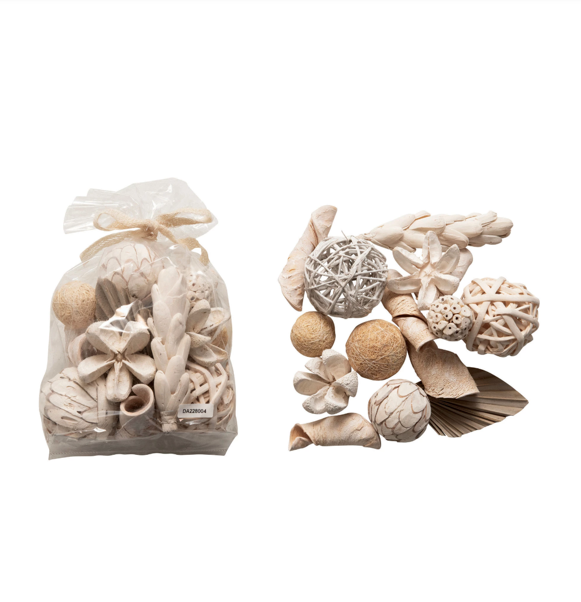 A variety of Creative Co-op Natural Plant Mix decorative objects, including spheres and carved ornaments made from natural materials typical of Scottsdale, Arizona, displayed next to a transparent bag tied with a ribbon, isolated on a white background.