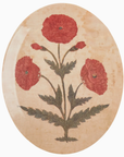 An Mughal Oval Tray depicting three red poppies with green stems and leaves, set against a beige, textured background suggestive of the rustic decor in a Scottsdale, Arizona bungalow.