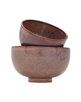 Two Linden Bowls by The Import Collection, each 8x8x5 inches in brown ceramic with a speckled, textured finish. One rests at an angle inside the other, both displayed against a white background.