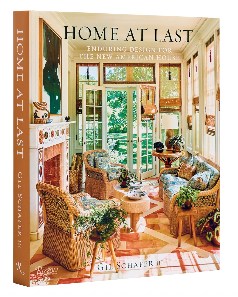 Cover of the book "Home at Last: Enduring Design for the New American House" by Gil Schafer III, featuring a cozy, sunlit room with Bungalow-style wicker furniture and plentiful greenery, published by Random House.
