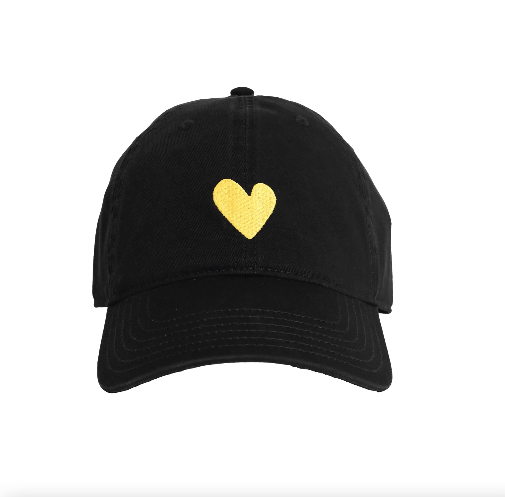 A black baseball cap from Kerri Rosenthal&#39;s KR CAP-Sule Collection, named the Embroidered Heart Hat, featuring a small yellow heart embroidered on the front center. This collegiate hat has a curved brim, visible stitching, and an adjustable back strap. The background is plain white.