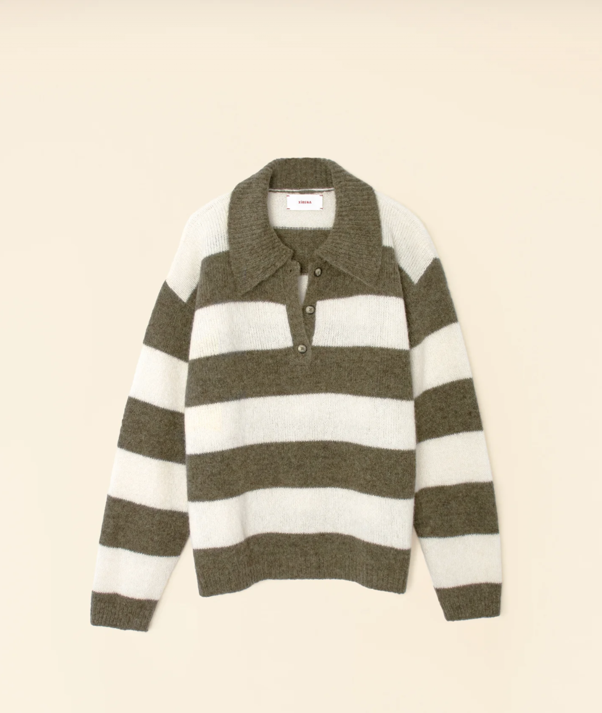 Introducing the Benton Sweater by Xirena, a long-sleeve baby alpaca blend sweater with a horizontal stripe pattern. Alternating between wide olive green and white stripes, this collegiate-inspired polo sweater features button-down collar details for added style against a plain, light beige background.