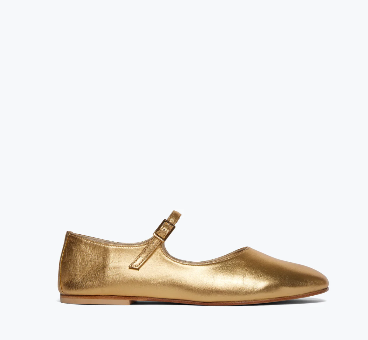 A single AUBREY Flat shoe by Freda Salvador, made from luxurious Italian leather in a gold hue, is showcased on a plain white background. The design includes a strap with a small buckle and offers ultimate comfort with its padded leather footbed.