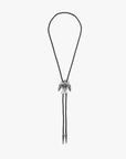 The "Be On The Look Out" by Mother is a black braided bolo tie with a silver bird silhouette slide and faux turquoise stone detail, featuring silver-tipped ends, set against a plain white background.