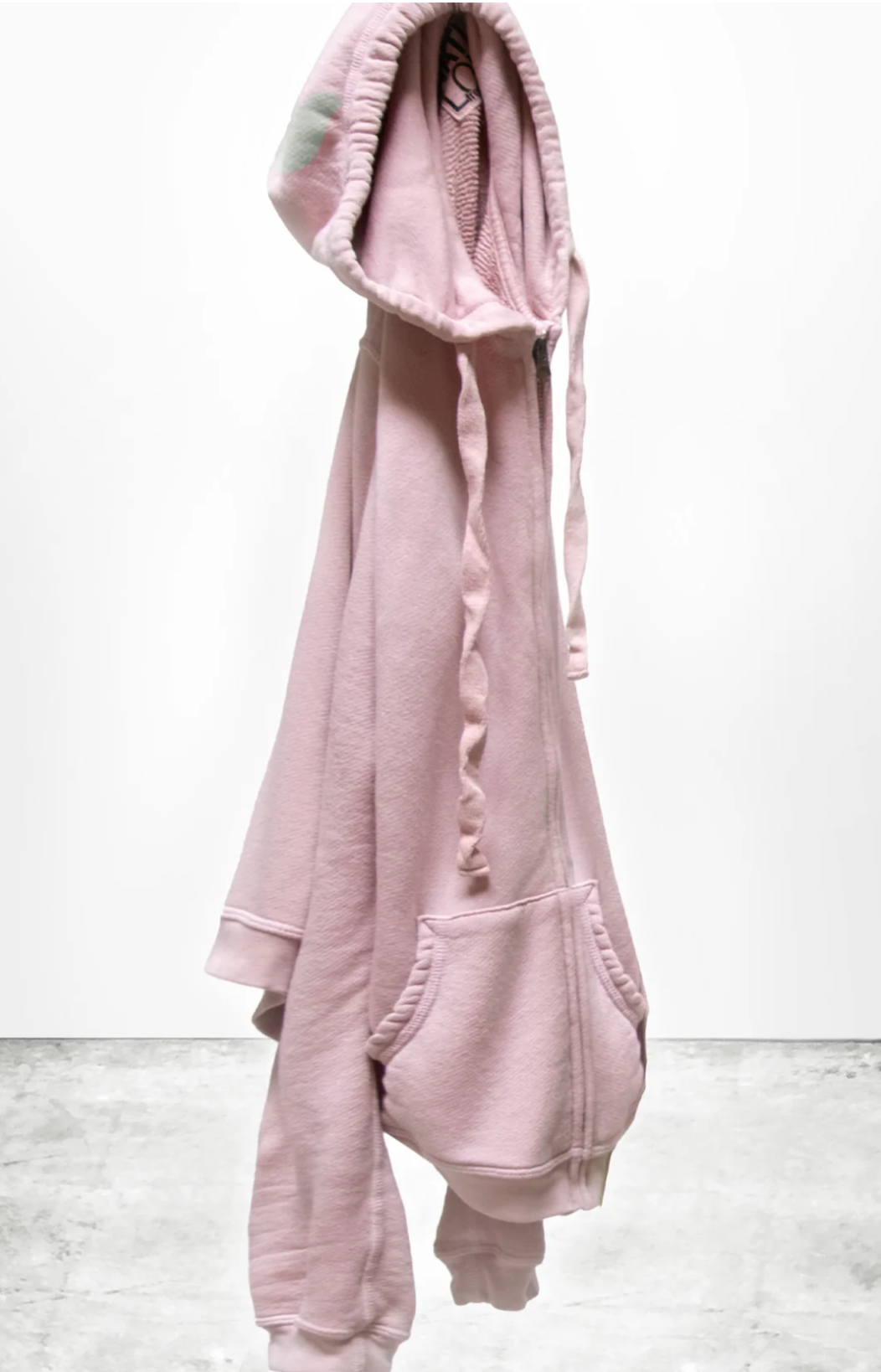 The SUPERFLUFF Lux Zip Hoodie from Free City (sparrow, LLC) in a pink shade is displayed against a plain white background. This lightweight French terry hoodie includes drawstrings and a front pocket, with subtly turned sleeves and hem. The soft fabric implies a cozy, casual style suitable for any wardrobe.