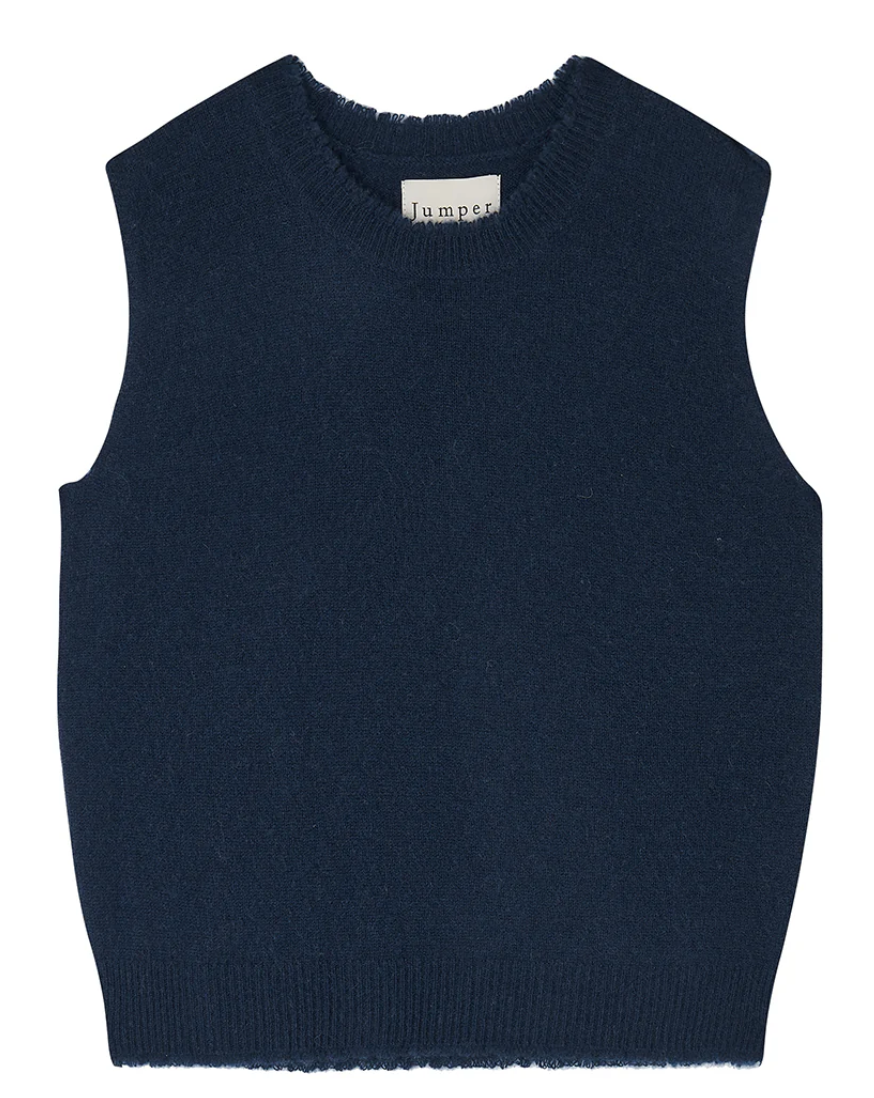 The Distressed Tank by Jumper 1 2 3 4/CR2 is a navy blue, sleeveless sweater vest with a round neckline, made from soft and fuzzy cashmere. It features a label at the back of the collar and maintains a simple, classic design.