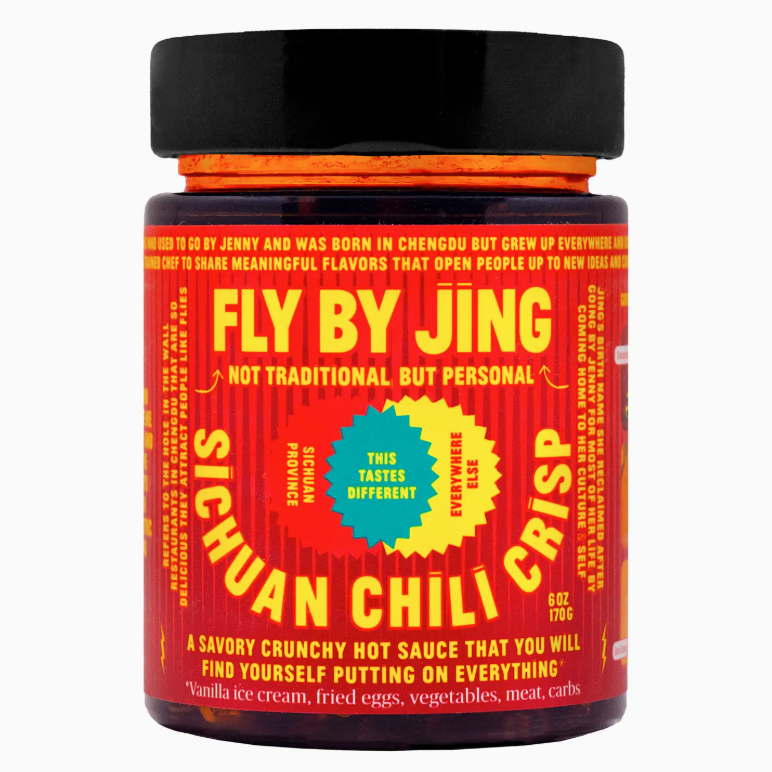 The Fly By Jing Sichuan Chili Crisp by Faire features a bright red and yellow label, showcasing its unique, flavorful sauce made with top-quality ingredients to add a spicy kick to various dishes.