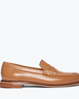 The ELBA Loafer by Freda Salvador is spotlighted against a simple white backdrop. This tan Italian leather shoe is handcrafted with stitch detailing around the toe, a small heel, and a smooth polished finish.