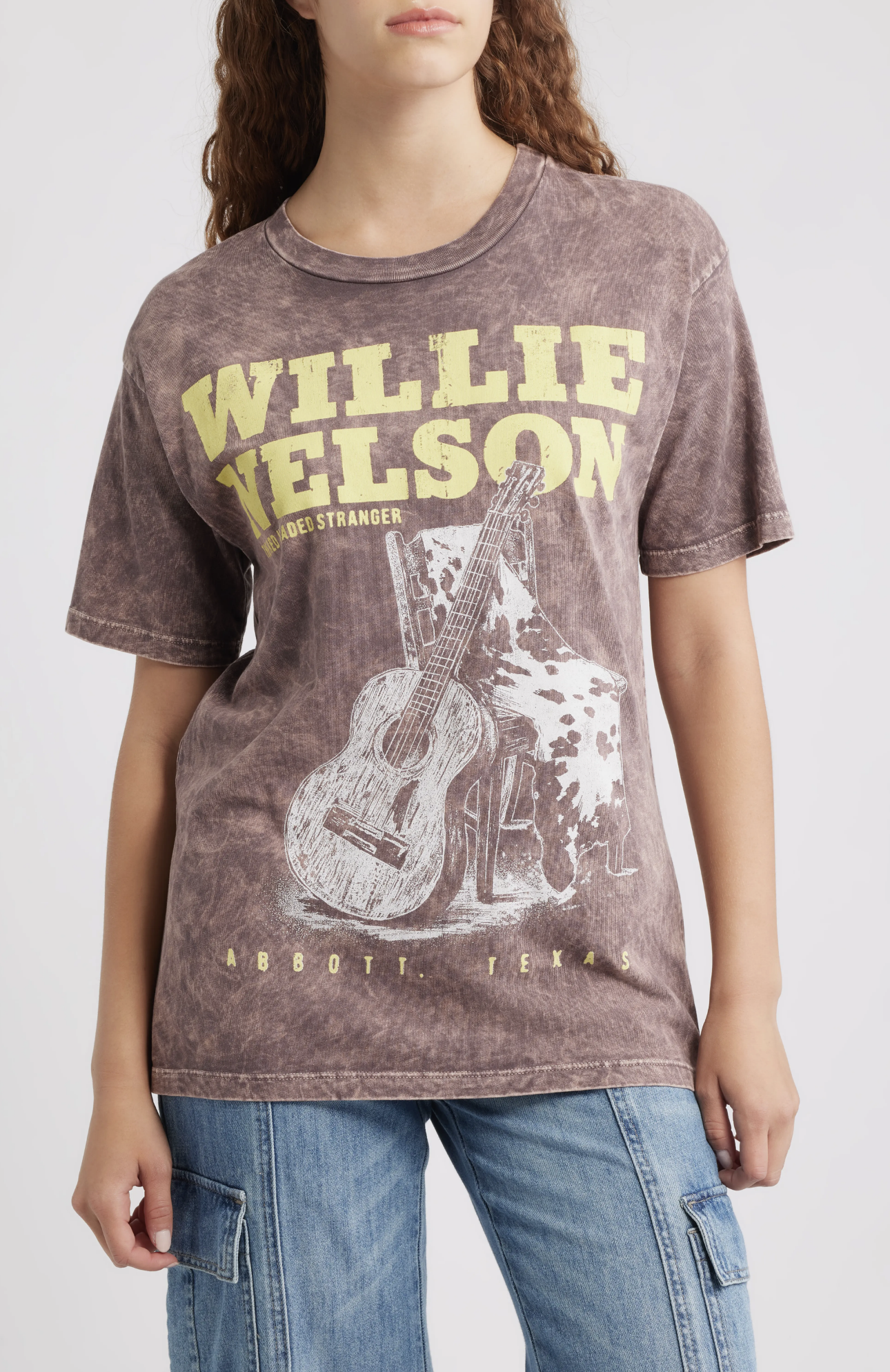 A woman wearing the DayDreamer Willie Nelson Red Headed Stranger graphic t-shirt.