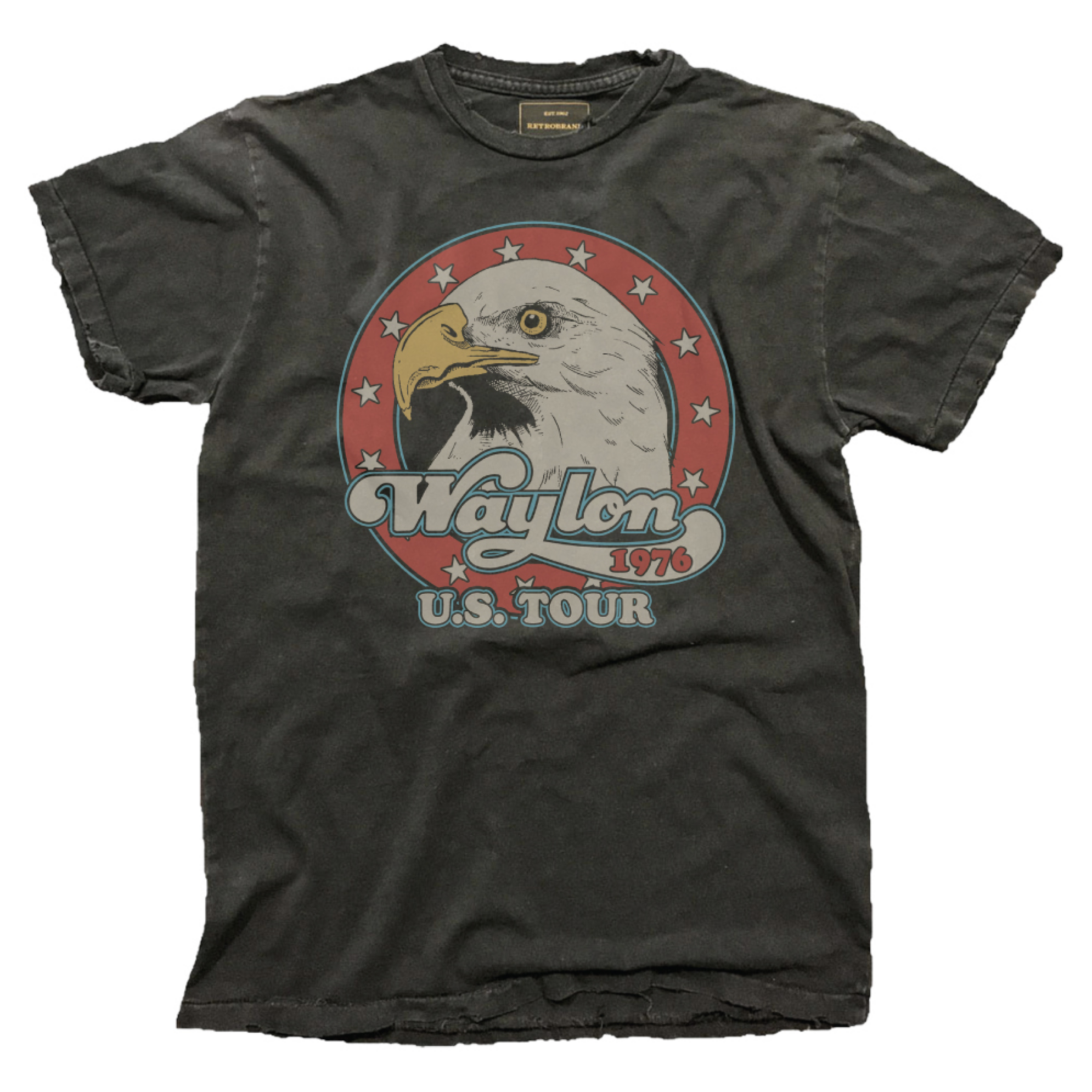 The Wildcat Retro Brands "Waylon Jennings U.S. Tour '76" tee is a vintage-style faded black shirt featuring a bald eagle head in a red star circle and retro "Waylon 1976 U.S. Tour" text on the front.