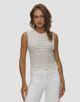 Gia Tweed sleeveless top by KUJTEN in light fabric, paired with white jeans against a subtle background.