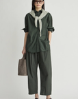 Apiece Apart oversized button down styled with a gray sweater, tote bag, brown shoes, and sunglasses for a relaxed look.