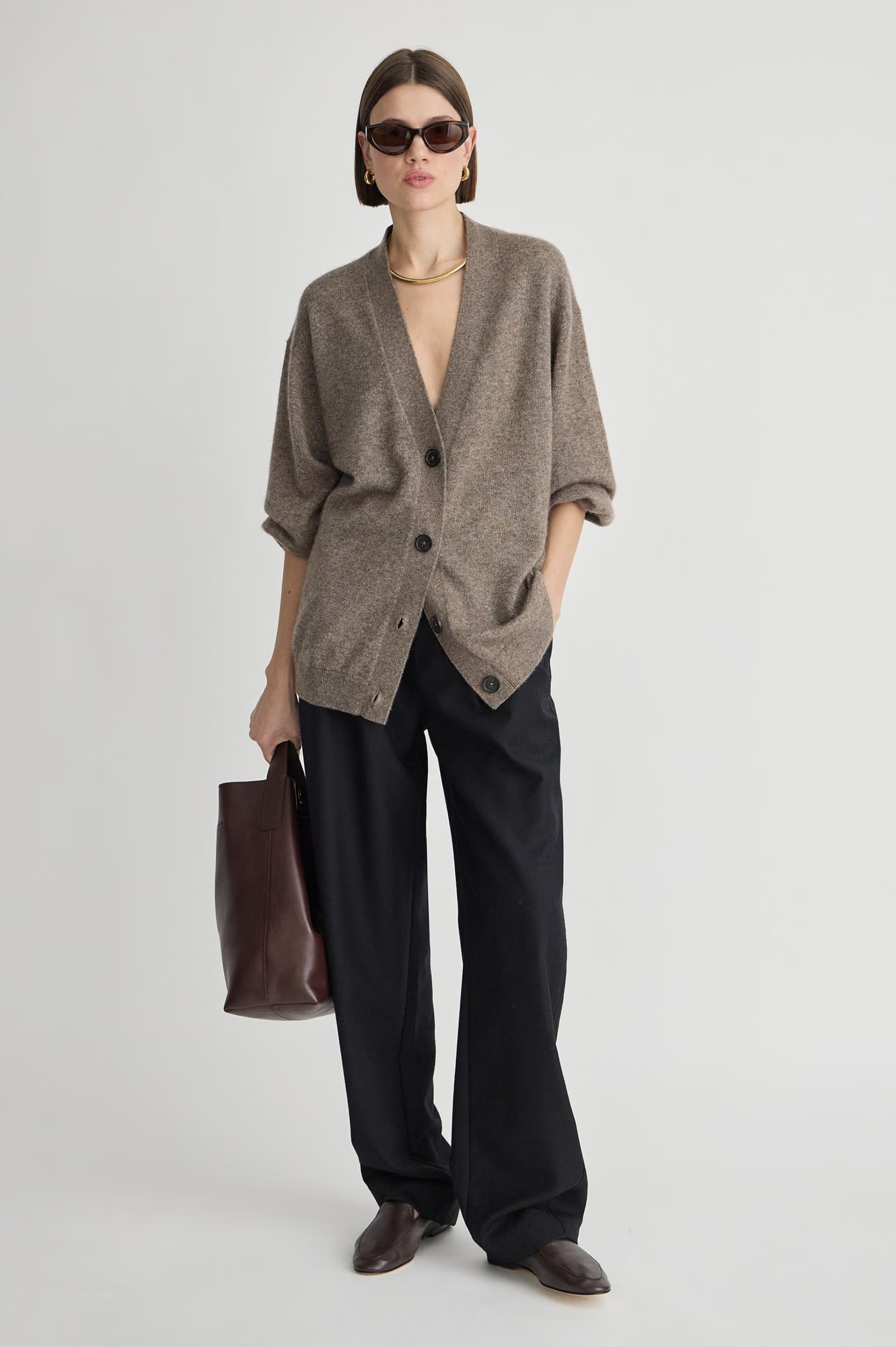 Apiece Apart Softest Tissue Weight Cardigan styled with wide-leg pants and brown accessories in a modern setting.