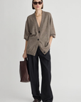 Apiece Apart Softest Tissue Weight Cardigan styled with wide-leg pants and brown accessories in a modern setting.