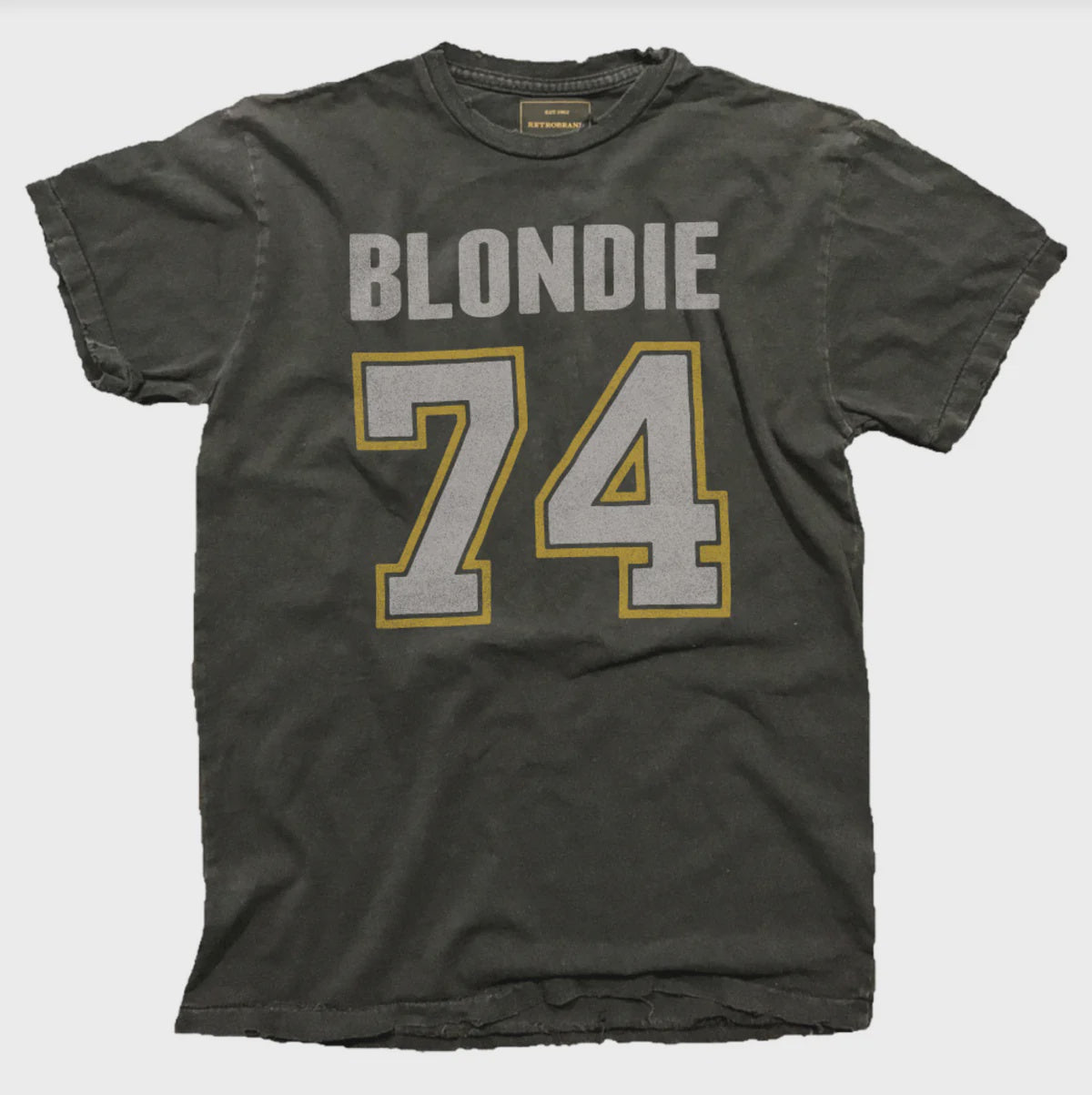 The Blondie '74 Tee by Wildcat Retro Brands is a worn black unisex t-shirt with a vintage feel, showcasing "BLONDIE" in large white letters above the bold "74" outlined in white and yellow on the front. Crafted from 100% cotton for maximum comfort.