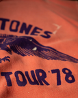 Close-up of a red vintage Shrunken Sweat T-shirt featuring "Stones Tour 78" in bold letters with a graphic design, focused on the text and graphic details in Scottsdale, Arizona. (Made Worn)