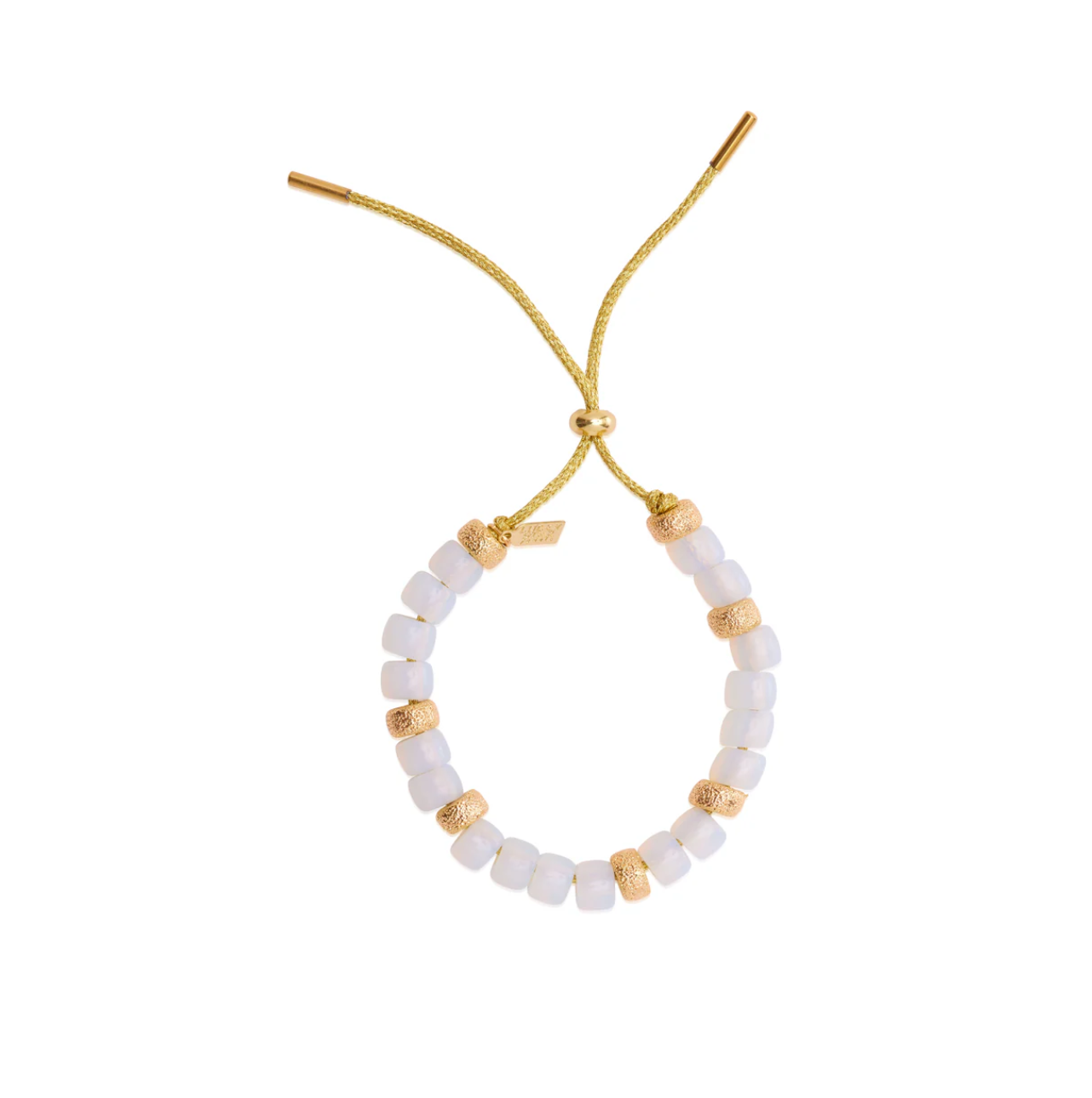 The Lucky Star Eye Candy Bracelet is a handcrafted bracelet made of white beads and gold accent beads, strung on a yellow adjustable slide closure cord. The cord features cylindrical gold ends, and a small tag adds a touch of detail, creating an elegant and stylish piece of eye candy.