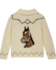 The Horse Lodge Cardigan by The Great Inc. is a beige knitted sweater featuring a detailed design of a horse's head on the back. The cardigan includes a shawl collar and decorative black trim accents on the shoulders and hem, with small black heart shapes near the hem and neckline, embodying rustic charm.