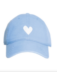 The Embroidered Heart Hat from Kerri Rosenthal's KR CAP-Sule Collection is a light blue baseball cap that features a white heart symbol on the front center. The cap includes stitching details along the brim and panels, providing a simple and cute design. Perfect for fans of collegiate hats, it comes against a clean white background.