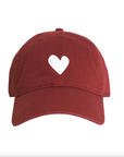 A maroon Embroidered Heart Hat by Kerri Rosenthal, featuring a simple white heart symbol on the front center from the KR CAP-Sule Collection, is positioned against a plain white background.