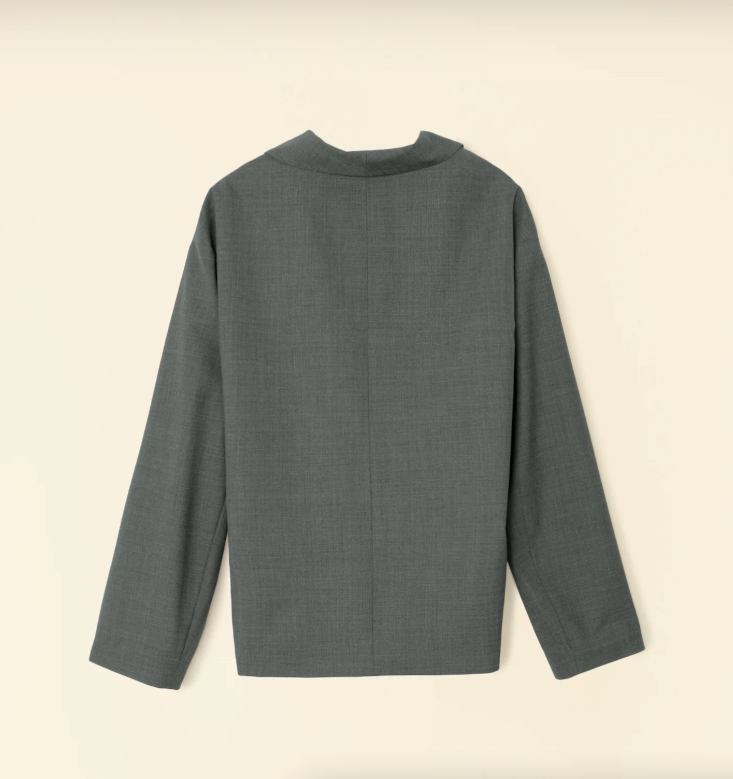 The Jonah Jacket by Xirena is a long-sleeved, dark gray garment with a high collar, displayed flat on a beige background to show its back view. It boasts a clean, minimalist design reminiscent of a soft-tailored look, featuring a straight hem and no visible embellishments.