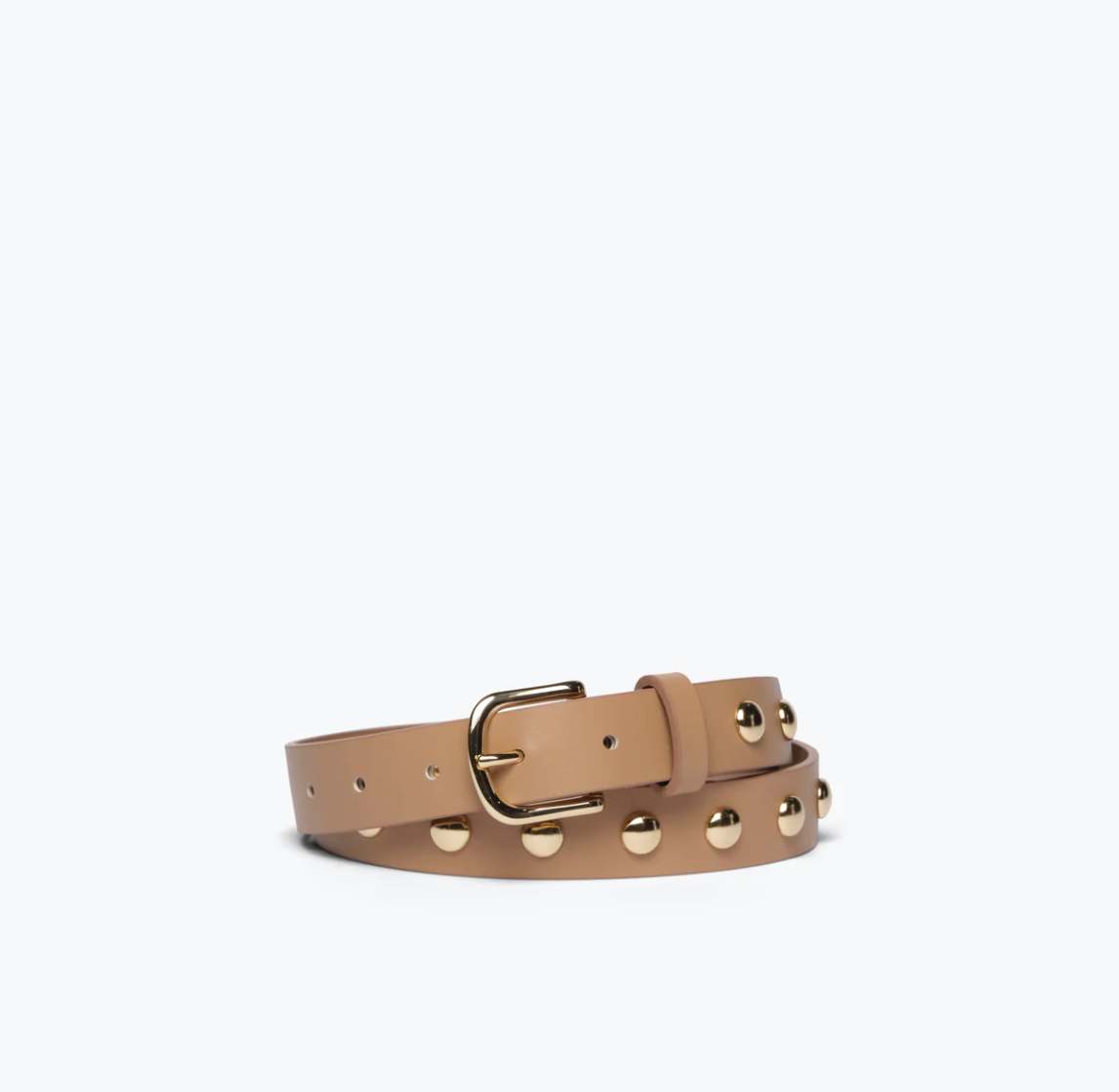 The Rebecca Black Calf Belt from Freda Salvador is lying on a white surface. The tan calf leather belt features small silver-plated metal studs evenly spaced along its length and has a gold buckle. It is neatly rolled with the end tucked under the buckle.