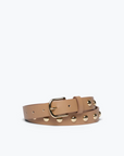 The Rebecca Black Calf Belt from Freda Salvador is lying on a white surface. The tan calf leather belt features small silver-plated metal studs evenly spaced along its length and has a gold buckle. It is neatly rolled with the end tucked under the buckle.