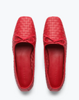 The JADA Flat by Freda Salvador is a pair of red woven ballet flats made from Spanish leather, featuring square toes and small bows on top, displayed from an overhead view against a white background.