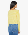 A person with long dark hair is wearing Mother's The Skipper Bell LS Tee, featuring yellow and white horizontal stripes, along with blue jeans. They stand facing away from the camera against a plain white background.