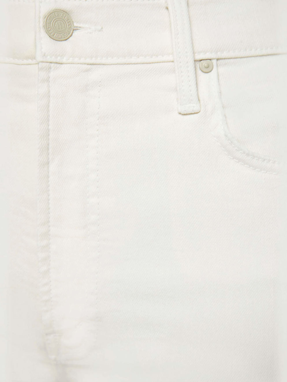 Close-up of The Rambler Zip Ankle by Mother highlighting the front pocket, belt loop, and button with a subtle embossed logo. The high-waisted off-white denim jeans showcase visible fabric texture and stitching.