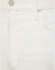 Close-up of The Rambler Zip Ankle by Mother highlighting the front pocket, belt loop, and button with a subtle embossed logo. The high-waisted off-white denim jeans showcase visible fabric texture and stitching.