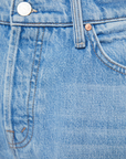 Close-up of Lil Dodger button Hover Cuff by Mother in blue denim, showcasing its texture, stitching, and metal button. The visible pocket and belt loop highlight the classic design and detailed craftsmanship typical of slouchy fit jeans.