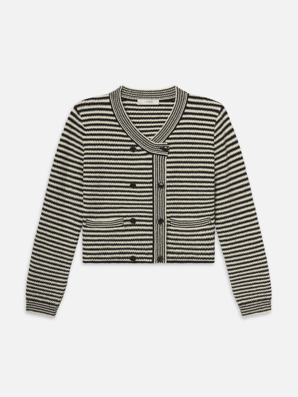 The Court Cardi by FRAME is a black and white striped cardigan with long sleeves, a V-neckline, black buttons, two front pockets, and a textured knit pattern.