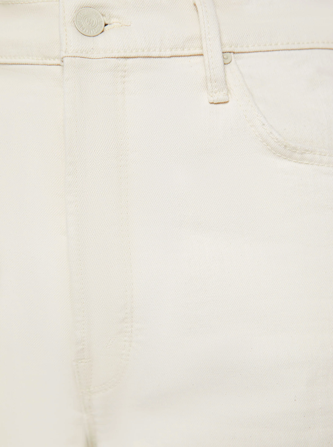 Close-up of The Spitfire Ankle Cuff jeans by Mother, showcasing the waistband, belt loops, button closure, and pocket stitching. Crafted from a superior cotton blend, these off-white straight-leg jeans perfectly embody the Act Natural style.