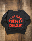 The Made Worn Madeworn Shrunken Sweatshirt is a black heavyweight cotton piece with bold red "MADEWORN 1971 SCHOOL OF ART" text, handmade in Los Angeles for a classic vintage look.