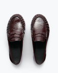 The Freda Salvador Sydney Crinkle Loafer is a shiny, dark brown Italian leather penny loafer with textured edge detailing, shown from above against a light, neutral background.