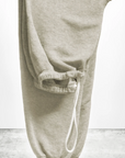A pair of light gray BASIC GOODNESS OG SWEATPANTS by Free City (sparrow, LLC) is folded over a surface with a white drawstring. The background is plain, and "freecity BASICgoodness" appears at the bottom.