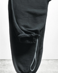 A pair of BASIC GOODNESS OG SWEATPANTS by Free City (sparrow, LLC), in black French terry and made in the USA, is folded with one leg over the other. An elastic waistband with drawstring and a “freecity BASICgoodness” logo are visible.