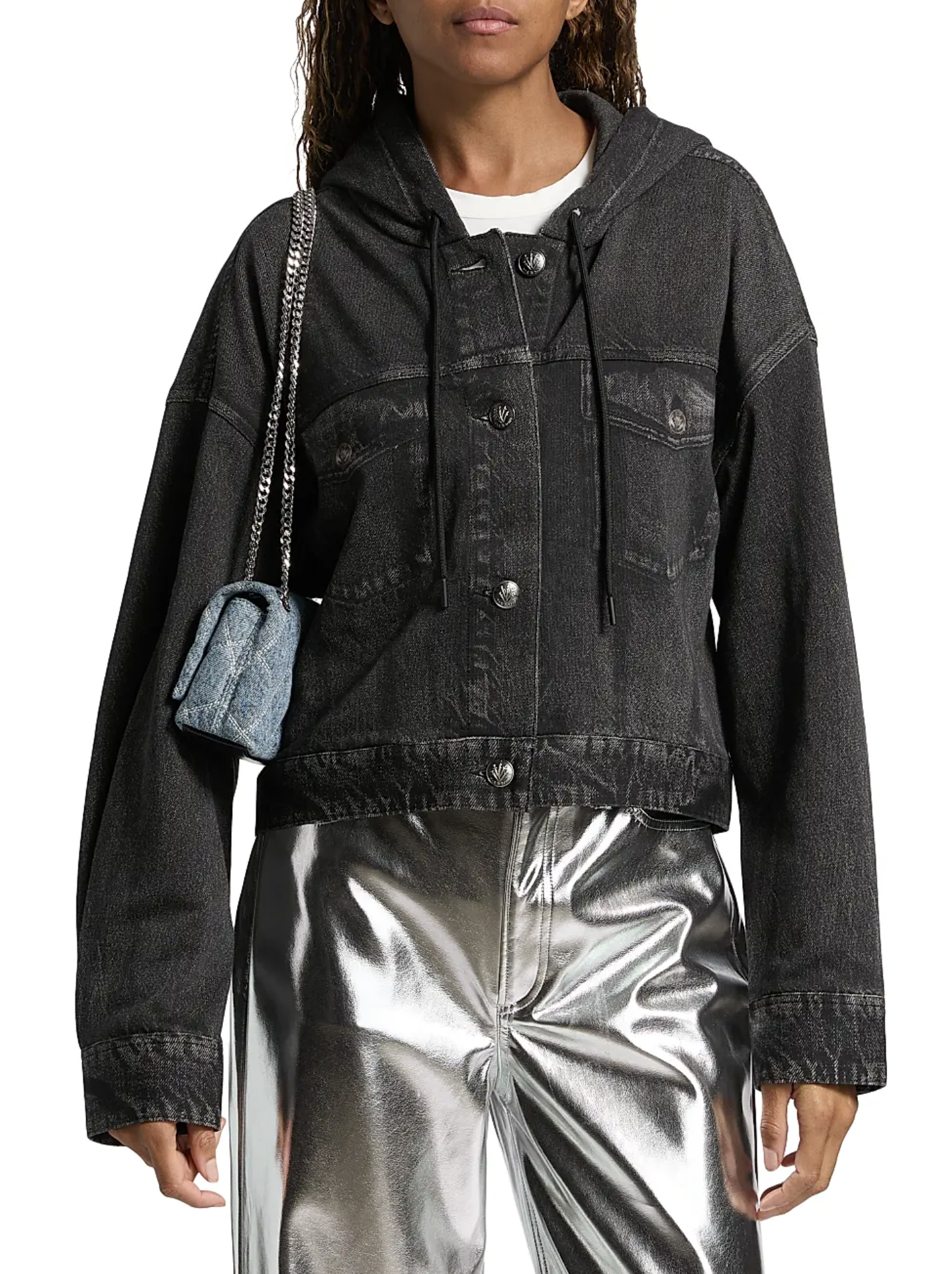 A woman wears a Rag & Bone miramar terry hood trckr jckt, styled with silver metallic pants and a small blue shoulder bag. The jacket features button closures and chest pockets for classic appeal.