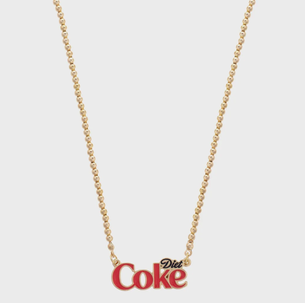 The Faire Coca-Cola Necklace features a gold-tone ball bead chain with a "Diet Coke" charm in red and gold letters, shown against a plain white background.